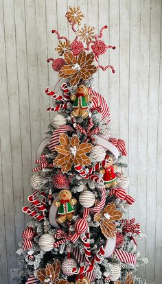 a christmas tree decorated with gingerbreads and candy canes