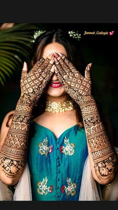 a woman with her hands on her face covered in hendikes and jewelry, covering her eyes