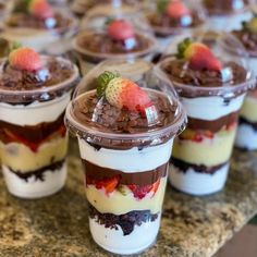 dessert cups with strawberries and chocolate on top