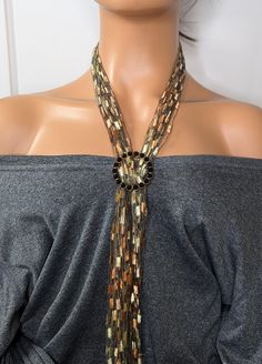 Elevate your style with our exquisite ladder yarn necklace, featuring a dazzling rhinestone ring. This handcrafted statement piece is perfect for any occasion, from casual wear to formal events. The unique ladder yarn design combined with the sparkling rhinestone ring creates a versatile accessory that can be paired with any outfit. Lightweight and comfortable, this necklace makes an ideal gift for friends, family, or even yourself. Add a touch of elegance to your jewelry collection today! This simple design makes it easy to dress up or down for any occasion, work or a night out. This elegant and charming scarf necklace is lightweight and looks great with any outfit a versatile look to enhance your style. Measuring 42 inches you can wear this piece with or without the scarf ring. *My goal Ladder Yarn Necklace, Ladder Yarn, Yarn Necklace, Scarf Rings, Scarf Necklace, Rhinestone Ring, Beaded Necklaces, Simple Design, Formal Event