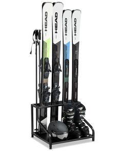 three skis and snowboards are in a rack on a white background for display