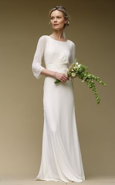 a woman in a white dress holding a bouquet