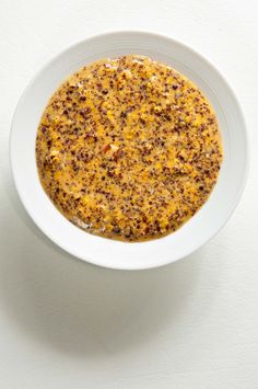 a white bowl filled with food on top of a table