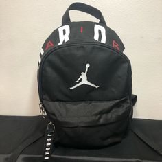 Black With Jordan Air Print On Top Two Zippers Black Letter Print Bag For Streetwear, Jordan Bag, Jordan Backpack, School Bag Essentials, Aesthetic Backpack, Jordan Air, Jordan Black, Bag Essentials, Womens Jordans