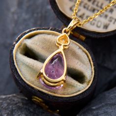 This very pretty pendant necklace features a pear cut amethyst and three single cut diamonds accenting above it. The pendant measures 19.3mm long by 9.2mm wide. The piece is crafted in 14k yellow gold and comes with a 14k yellow gold 18 inch cable chain with jump rings so it can also be worn at 16 and 17 inches long. Yellow Gold Pear-shaped Amethyst Jewelry, Pear-shaped Amethyst Jewelry In Yellow Gold, Yellow Gold Amethyst Teardrop Pendant Jewelry, Pear-shaped Amethyst Necklace As A Gift, Pear-shaped Amethyst Jewelry As Gift, Gift Pear-shaped Amethyst Necklaces, Pear-shaped Amethyst Necklace For Gift, Gift Pear-shaped Amethyst Necklace, Yellow Gold Teardrop Gemstone Drop Necklace