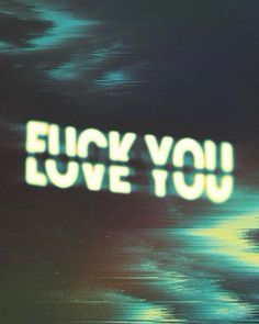 the words'i love you'are projected in green and blue colors on a black background