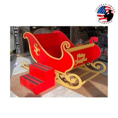 a red and gold sleigh with merry christmas written on it