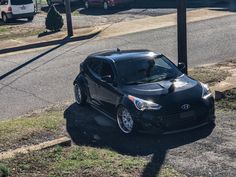 a black car parked on the side of a road