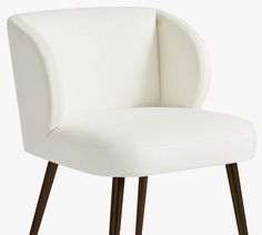 an upholstered white chair with wooden legs