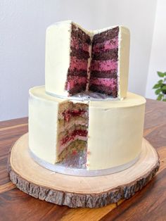 there is a cake that has been cut in half on top of a wooden table