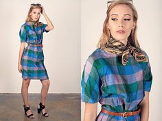 "Very endearing blue/green plaid dress with splashes of pink and purple. It has a slightly iridescent look to to the fabric, mid sleeves, tight waist, wiggle skirt, metal back zipper, black lining on inside, and round high neckline. ➽ brand: no tag ➽ material: rayon acetate blend ➽ condition: great vintage shape, no flaws! ➽ model stats: 32\" 24\" 34\" 5'9 ➽ size: medium ➽ measures: pit to pit 38\" / waist 29\" / length 39 1/2\" / bust 36\" / hips 40\" ➽ Apple Branches Vintage applebranchesvinta Fitted Blue Plaid Casual Dress, Fitted Blue Plaid Dress For Spring, Blue Knee-length Plaid Dress For Spring, Fitted Plaid Knee-length Dress For Daywear, Fitted Knee-length Plaid Dress For Daywear, Spring Plaid Short Sleeve Dress For Work, Spring Workwear Plaid Dress With Short Sleeves, Summer Plaid Short Sleeve Dress For Work, Spring Short Sleeve Plaid Dress For Work