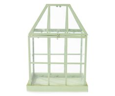 a small green glass house on a white background