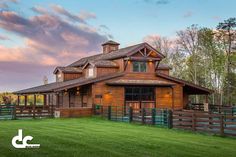 a large wooden building sitting on top of a lush green field