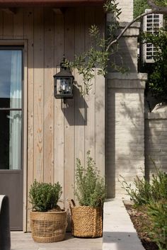 two planters on the outside of a house