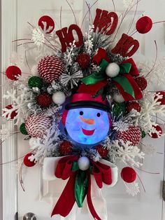 a christmas wreath with a snowman on it