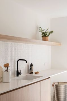 a kitchen counter with a sink, faucet and soap dispenser