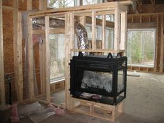 an unfinished room with a fireplace in the middle