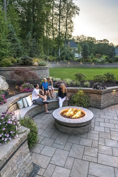 several people sitting around an outdoor fire pit