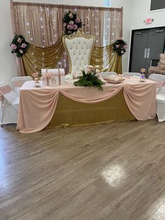 a banquet table set up with pink and gold decorations