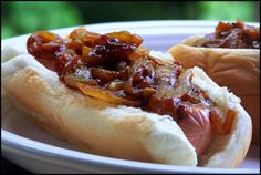 two hot dogs on buns covered in chili