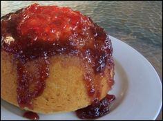 a bundt cake covered in jam on a white plate