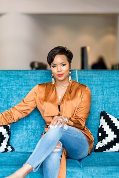 a woman sitting on top of a blue couch