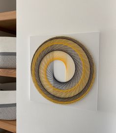 two circular artwork pieces hanging on the wall