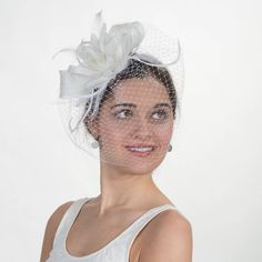 Complex and elegant, this sinamay flower comb creates an delicate look that makes it perfect for any formal occasions. It is the final touch needed for any outfit. The beautiful flower is topped with feathers and a veil creating an exquisite look. Material: Sinamay Handmade in USA with Imported material. Elegant Tulle Mini Hats For Spring, Elegant Tulle Fascinator For Kentucky Derby, Elegant Tulle Fascinator, Elegant Tulle Mini Hats For Wedding, Elegant Tulle Headpiece For Spring, Elegant Fitted Tulle Fascinator, Fitted Feather Fascinator For Wedding, Flower-shaped Fitted Fascinator For Weddings, Fitted Flower Fascinator For Wedding