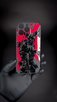 a hand holding up a cell phone case with a painting on the back of it