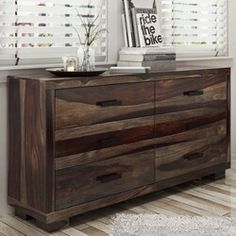 a wooden dresser sitting in front of a window