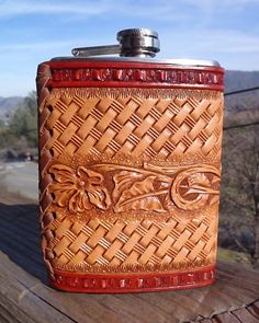 the flask is made out of leather and has an intricate design on it's side