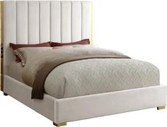 a bed with a white upholstered headboard and brown pillows on top of it