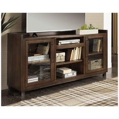 an entertainment center with a flat screen tv on it's stand and bookshelves