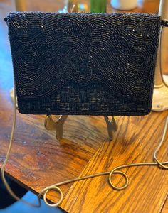 "This is a gorgeous vintage DELTA hand beaded black purse. It was made in 1960's and is is stunning condition. It is lightweight and charming.  Bring this purse to add some sparkle to your happy places! Great for a Mother's Day gift too! Excellent vintage condition! This elegant purse is approx 5\" tall and 7\" across. The metal chain can be tucked in purse. Length of chain is approx 22\" long. NO rips, tears, smells, or beads missing. Looks like new! Thanks for stopping by my Etsy shop. Keri" Black Beaded Evening Bag For Wedding, Elegant Beaded Evening Bag For Vintage Events, Black Beaded Formal Evening Bag, Antique Beaded Evening Bag For Party, Antique Beaded Evening Bag, Vintage Black Embellished Bags, Vintage Black Evening Bag For Party, Elegant Black Beaded Evening Bag For Formal Occasions, Vintage Black Clutch For Evening