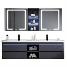 a bathroom vanity with two sinks and lighted mirrors