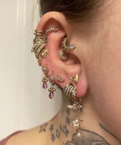 a woman with tattoos and piercings on her ear