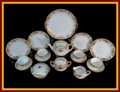 an assortment of white and gold china