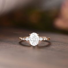 a close up view of a diamond ring on a table