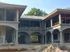 a house under construction with scaffolding on the front and second story in progress