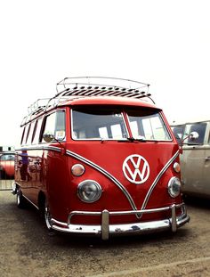 an old vw bus parked in a parking lot