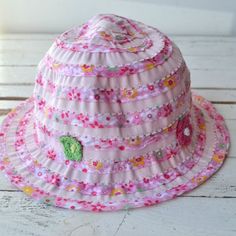 A beautiful child's summer hat in pastel bright pink and white. The hat features beautiful flower illustrations and some crochet style flowers in pink and orange.The ideal summer accessory for those little ones on the beach enjoying the sunshine.The hats are size 7 - 10, 3 - 6 & 1 - 2 years and we have limited availability of these.Made from:100% polyesterDimensions: 7 - 10 years3 - 6 years1 - 2 years Beach Towel Set, Flower Illustrations, Personalized Socks, Baby Sun Hat, Crochet Style, Personalized Beach Towel, Star Children, Summer Hat, Cute Socks