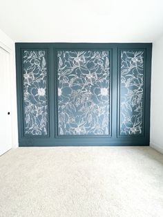 an empty room with three glass panels on the wall and carpeting in front of it