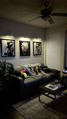 a living room filled with furniture and pictures on the wall