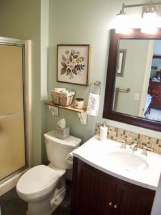 a bathroom with a toilet, sink and shower