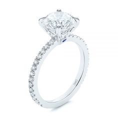 a diamond engagement ring on a white background