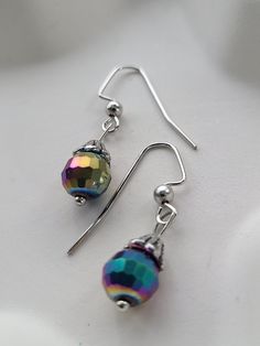 These iridescent earrings are a cute little dangle that can go with so many occasions. Great for anyone who wants a little shine. Elegant Rainbow Earrings, Rainbow Crystal Drop Earrings For Gift, Handmade Iridescent Drop Earrings, Rainbow Metal Drop Earrings, Iridescent Drop Earrings With Matching Jewelry, Iridescent Ear Wire Earrings For Gift, Handmade Iridescent Crystal Earrings For Party, Iridescent Drop Earrings Jewelry Set, Iridescent Drop Earrings With Matching Jewelry Set