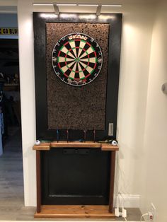 a dart board mounted to the side of a wall