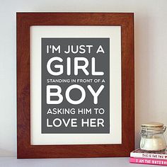 a pink framed print with the words i'm just a girl boy, asking him to love her