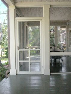 the front porch is clean and ready to be used as an outdoor dining area for entertaining