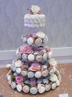 a three tiered cake made out of cupcakes